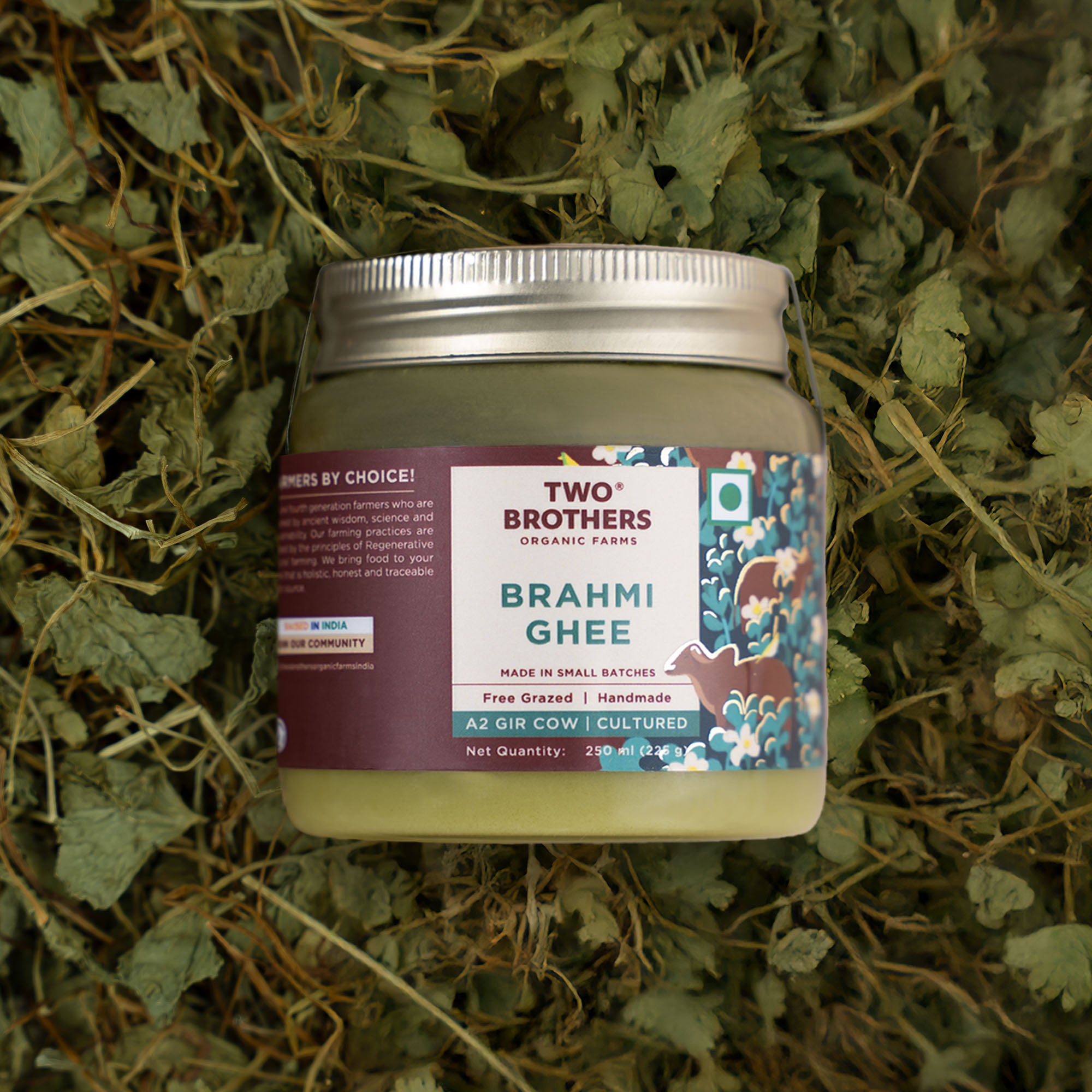 Two Brothers Organic Farms Brahmi Ghee jar on a bed of herbs