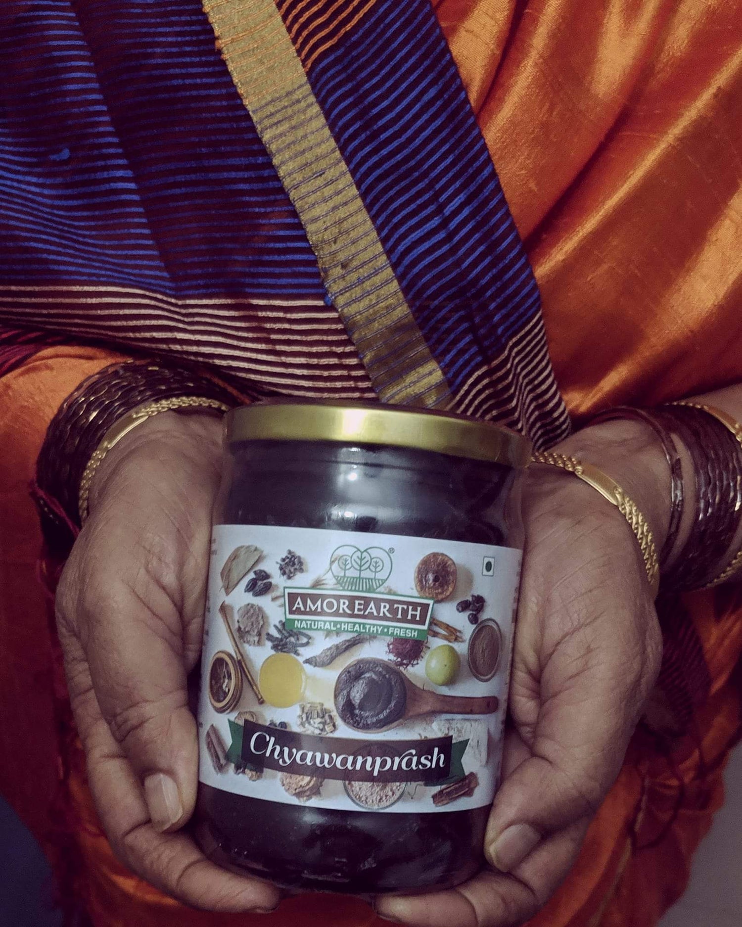 Women holding a jar of Limited Edition Amlaprash made by Two Brothers Organic Farms